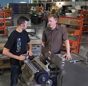 ACCELERATING GREATNESS Rick Urschel, CEO of employee-owned Urschel Laboratories Inc., with machine assembler Jesse Nielsen.