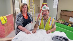 BUILDING A CAREER Ashley Dickinson, Porter Health Care System’s chief operating officer, meets with Walsh Construction project superintendent Dan Prochno at the site of Porter’s new emergency room in Valparaiso. The new ER is set to open in the early fall.
