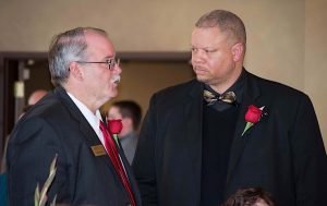 IMPACTING LIVES Left photo: Mike Sutton, pastor at LaPorte Campus Liberty Bible Church, congratulates Dion Campbell, Michigan City Police Department resource officer.