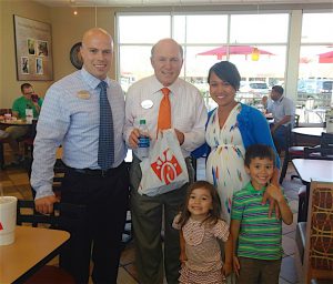 “WE PLANNED TO GROW OLD HERE,” says Chick-fil-A local owner Tyler Carter, pictured with wife Mya, children Josh and Grace, and Dan Cathy, president and CEO of Chick-fil-A Inc.