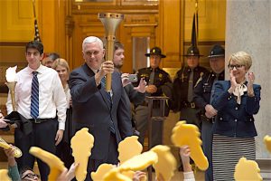 CARRYING THE TORCH Gov. Mike Pence prepares for the Indiana Bicentennial Torch Relay.