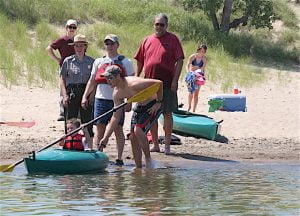 FLOATING IN FOR A VISIT The National Park Service’s kayaking program draws visitors to the lakefront.