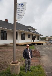 “A PASSION FOR SUCCESS” Jon Groth, area director/principal at Porter County Career and Technical Education, stands by the historic 1912 Grand Truck rail depot that was moved onto the school campus and is being converted into a 21st century classroom.