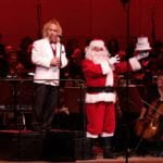 Maestro Kirk Muspratt celebrates the Symphony’s 75th birthday with Santa.